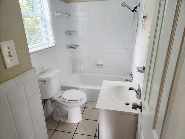 full bathroom featuring tile patterned floors, tiled shower / bath, toilet, and vanity