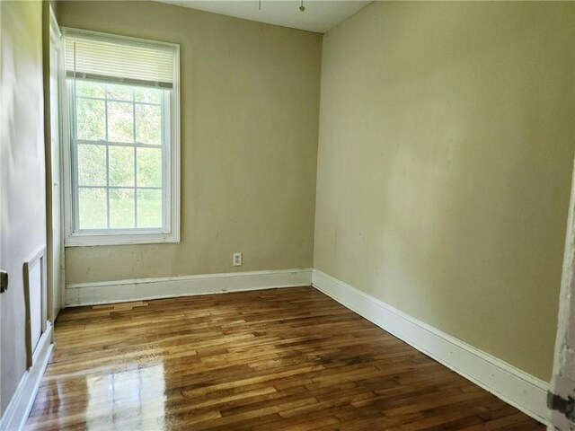 unfurnished room with wood-type flooring