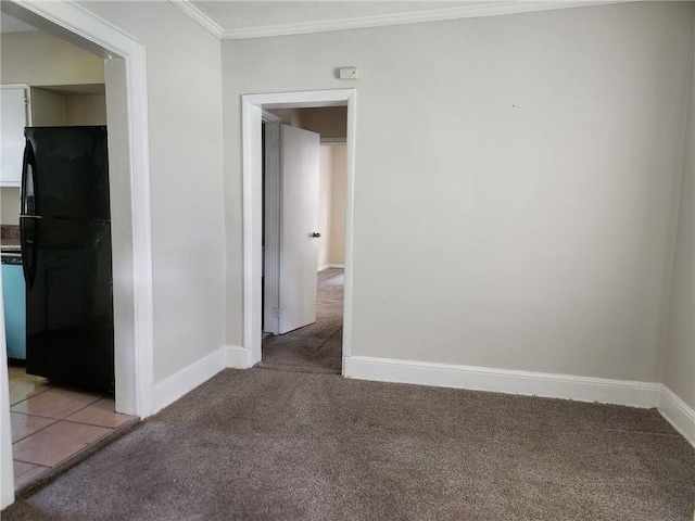 carpeted spare room featuring crown molding