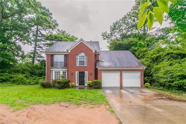2191 Phillips Rd, Lithonia, GA 30058 - colonial home with an attached garage, brick siding, driveway, and a front lawn