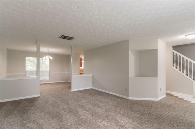 2191 Phillips Rd, Lithonia, GA 30058 - empty room with carpet floors, a textured ceiling, stairway, a chandelier, and baseboards