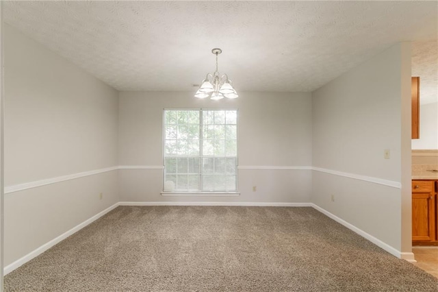 2191 Phillips Rd, Lithonia, GA 30058 - empty room with a chandelier, light colored carpet, a textured ceiling, and baseboards