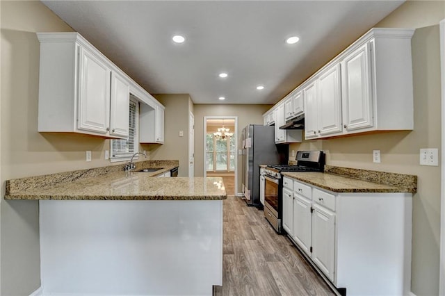 1400 Scenic Brook Trl SW, Conyers, GA 30094 - kitchen with appliances with stainless steel finishes, a sink, light wood-type flooring, white cabinets, and recessed lighting