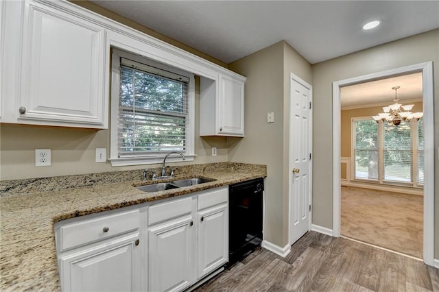 1400 Scenic Brook Trl SW, Conyers, GA 30094 - kitchen with black dishwasher, a sink, wood finished floors, white cabinetry, and a chandelier