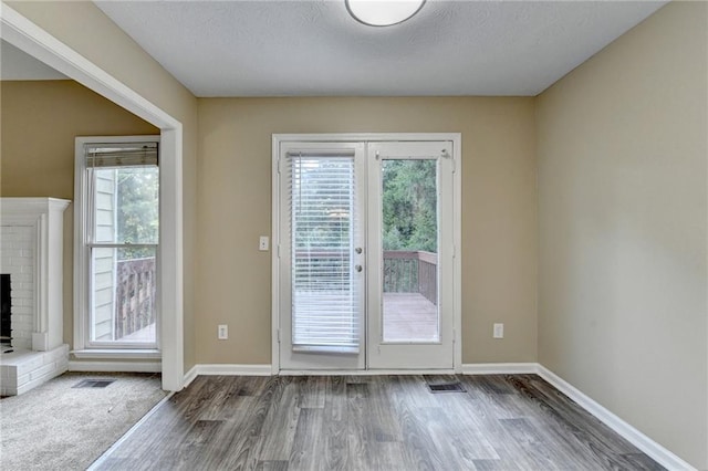 1400 Scenic Brook Trl SW, Conyers, GA 30094 - doorway to outside featuring wood finished floors, baseboards, french doors, and a brick fireplace