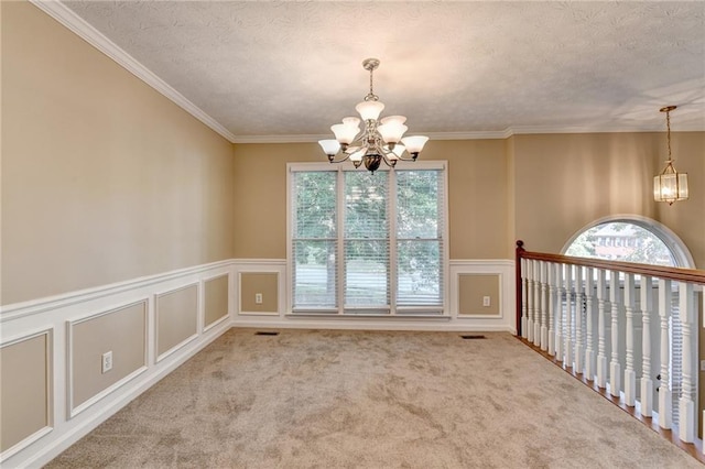 1400 Scenic Brook Trl SW, Conyers, GA 30094 - carpeted empty room with a chandelier, a decorative wall, crown molding, a wainscoted wall, and a textured ceiling