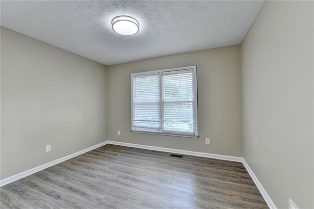 1400 Scenic Brook Trl SW, Conyers, GA 30094 - unfurnished room with wood finished floors, a textured ceiling, and baseboards