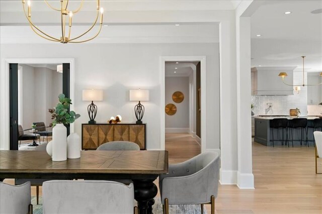 dining room featuring an inviting chandelier and light wood-type flooring