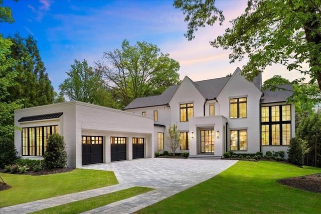 view of front of property featuring a lawn and a garage