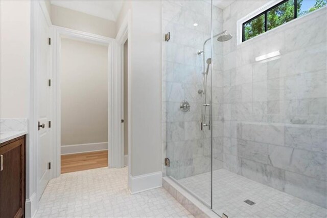 bathroom with wood-type flooring, an enclosed shower, and vanity