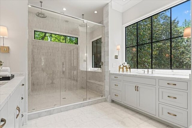 bathroom featuring vanity and a shower with door