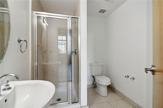 bathroom with tile patterned floors, toilet, an enclosed shower, and sink
