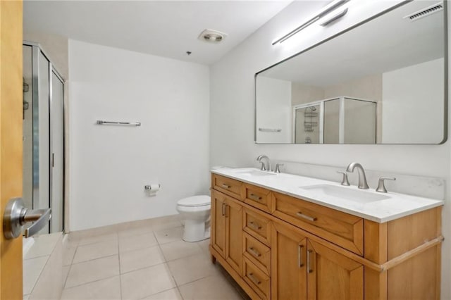 bathroom with vanity, walk in shower, tile patterned floors, and toilet
