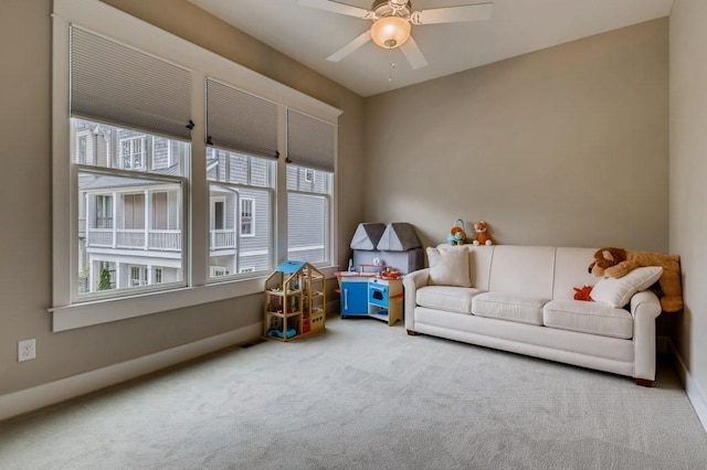 living room with light carpet and ceiling fan