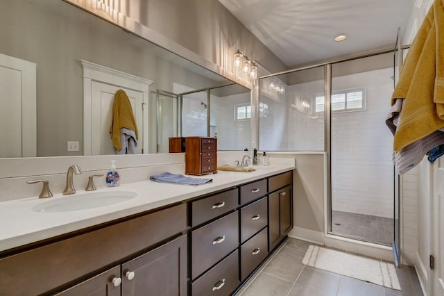 bathroom with tile floors, dual vanity, and an enclosed shower