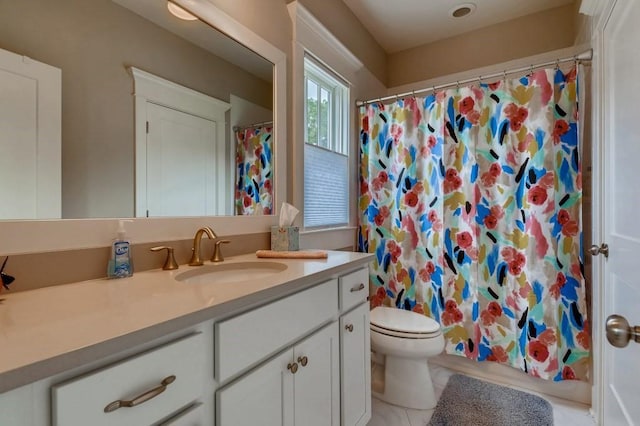 bathroom with tile floors, toilet, and vanity