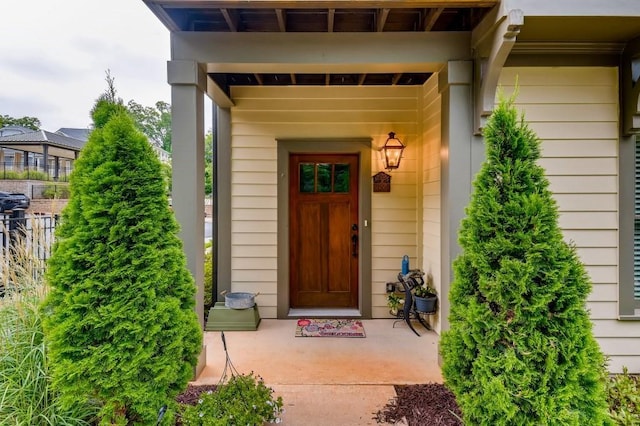 view of exterior entry with a patio area