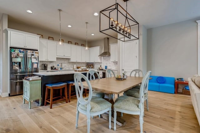 dining room with a chandelier and light hardwood / wood-style flooring