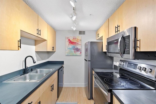 387 Ralph Mcgill Blvd NE Unit K, Atlanta, GA 30312 - kitchen with appliances with stainless steel finishes, a sink, dark countertops, light wood-type flooring, and a textured ceiling