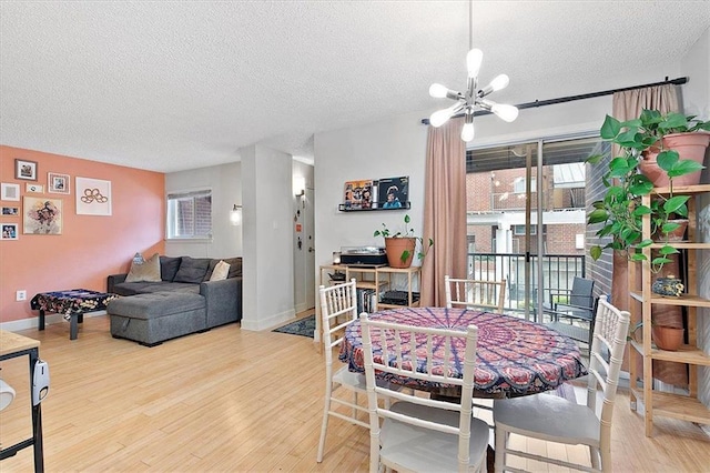 387 Ralph Mcgill Blvd NE Unit K, Atlanta, GA 30312 - dining area with a textured ceiling, a chandelier, wood finished floors, and baseboards