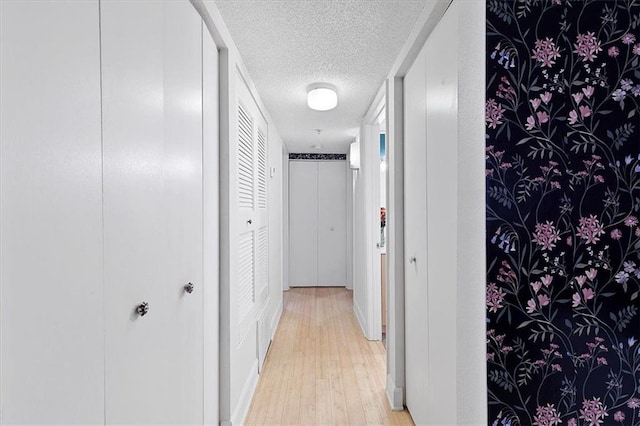 387 Ralph Mcgill Blvd NE Unit K, Atlanta, GA 30312 - corridor featuring a textured ceiling, light wood-style flooring, and baseboards