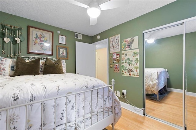 387 Ralph Mcgill Blvd NE Unit K, Atlanta, GA 30312 - bedroom featuring a closet, wood finished floors, baseboards, a ceiling fan, and a textured ceiling