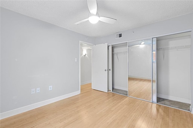 387 Ralph Mcgill Blvd NE Unit K, Atlanta, GA 30312 - unfurnished bedroom with a textured ceiling, light wood-style floors, a closet, and baseboards