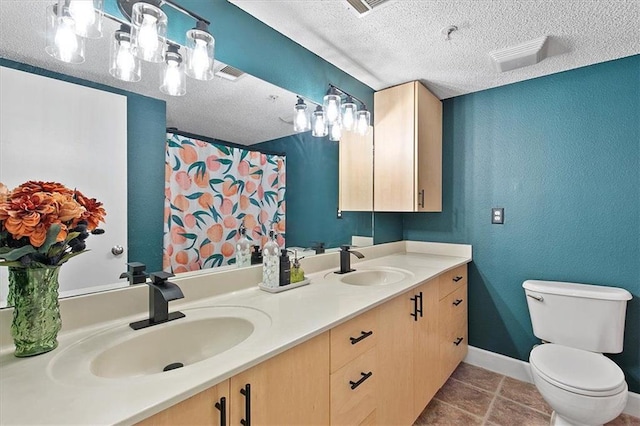 387 Ralph Mcgill Blvd NE Unit K, Atlanta, GA 30312 - bathroom with double vanity, a textured ceiling, toilet, tile patterned flooring, and baseboards
