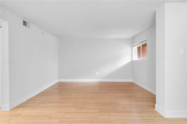 387 Ralph Mcgill Blvd NE Unit K, Atlanta, GA 30312 - empty room featuring light wood finished floors, a textured ceiling, and baseboards