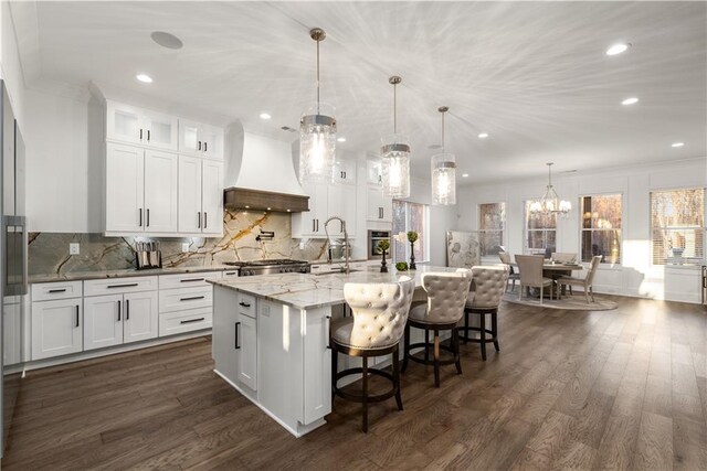 kitchen featuring a center island with sink, white cabinetry, custom exhaust hood, and dark hardwood / wood-style flooring