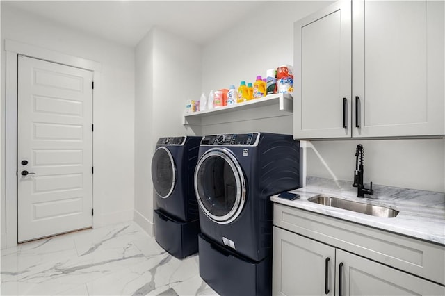 washroom featuring washer and dryer, cabinets, and sink