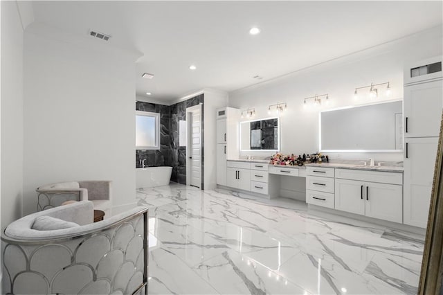 bathroom with a bathtub, crown molding, and vanity