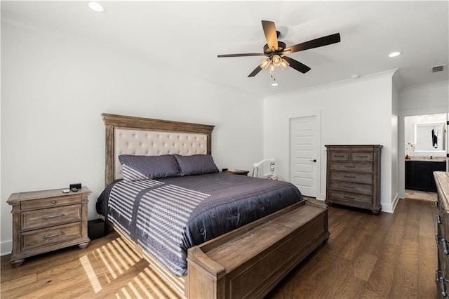 bedroom with connected bathroom, ceiling fan, and dark hardwood / wood-style floors