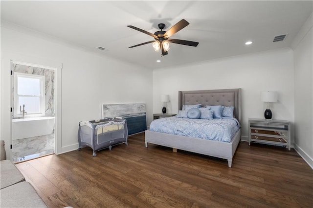 bedroom featuring ornamental molding, dark hardwood / wood-style flooring, ensuite bath, and ceiling fan