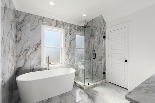 bathroom with tile walls and shower with separate bathtub