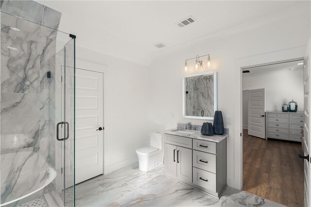 bathroom featuring toilet, an enclosed shower, hardwood / wood-style flooring, and vanity