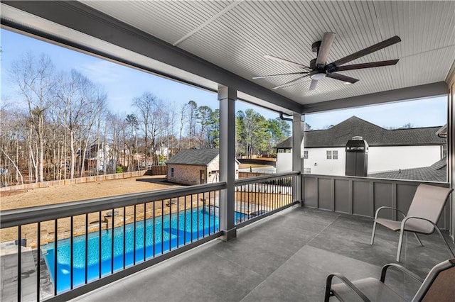 view of patio with a fenced in pool and ceiling fan