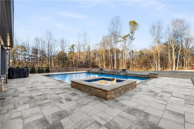 view of pool featuring an in ground hot tub and a patio