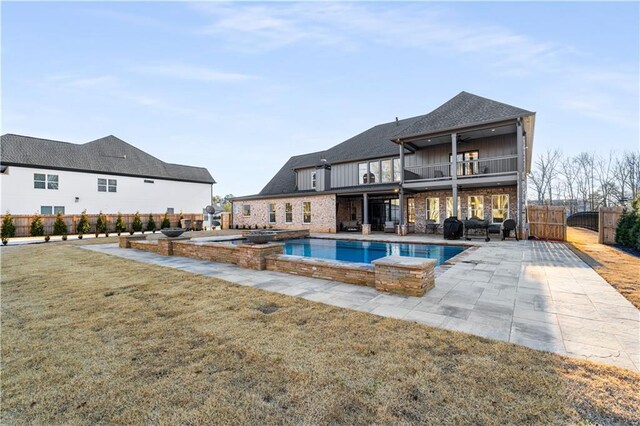 view of pool featuring a yard, a patio, and an in ground hot tub