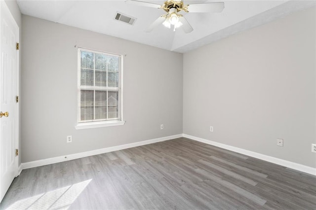 spare room with wood-type flooring and ceiling fan