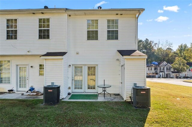 rear view of house featuring a yard, a patio area, and central AC unit