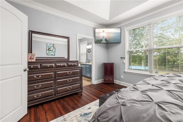 bedroom featuring crown molding, connected bathroom, dark wood-style flooring, and baseboards