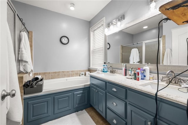 bathroom with double vanity, a bath, tile patterned floors, a shower stall, and a sink