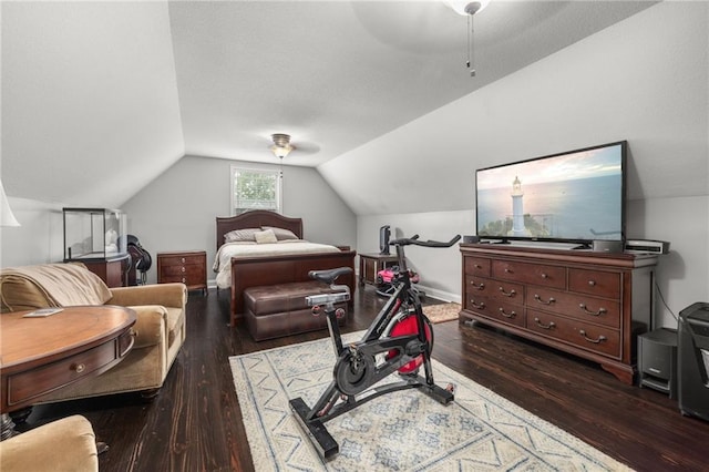 bedroom with a ceiling fan, baseboards, wood finished floors, and lofted ceiling