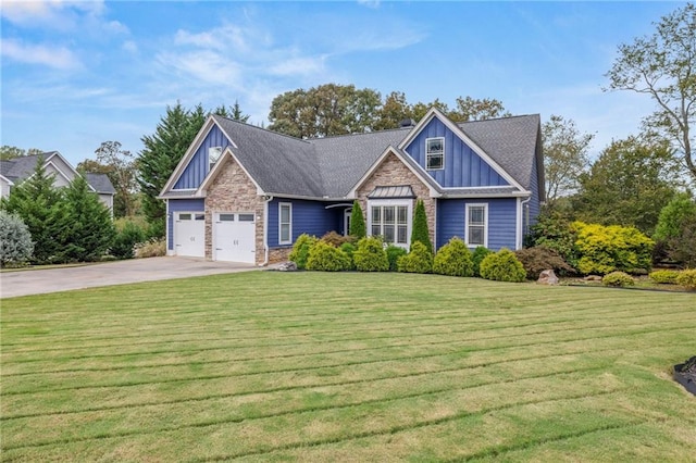 craftsman-style home featuring a front yard, stone siding, board and batten siding, an attached garage, and driveway