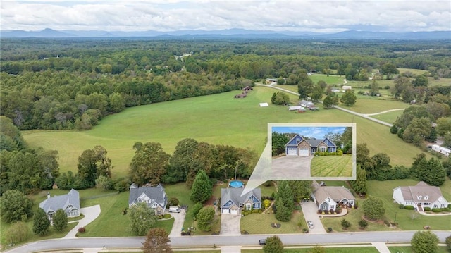 drone / aerial view featuring a wooded view