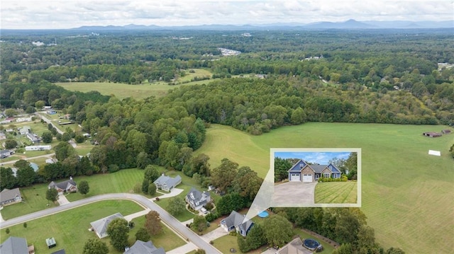 drone / aerial view with a mountain view and a wooded view