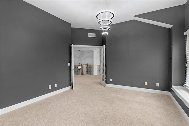 interior space featuring light colored carpet and a notable chandelier