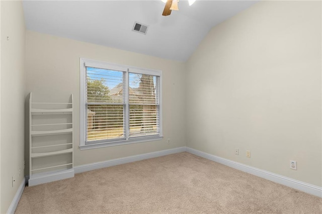 carpeted empty room featuring ceiling fan and lofted ceiling