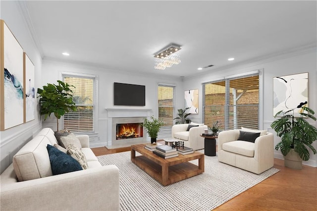 living room featuring crown molding and light hardwood / wood-style flooring